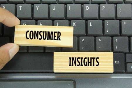 laptop keyboards and wooden boards with the words Consumer Insights